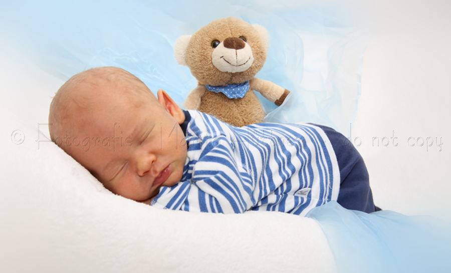 Ein kleines Baby mit einem Kuscheltier