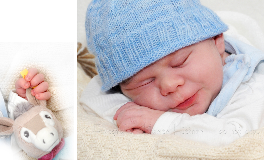kleines lächelndes Baby mit Mützchen